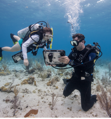 divers at ocean floor testing waterproof ipad product prototype 
